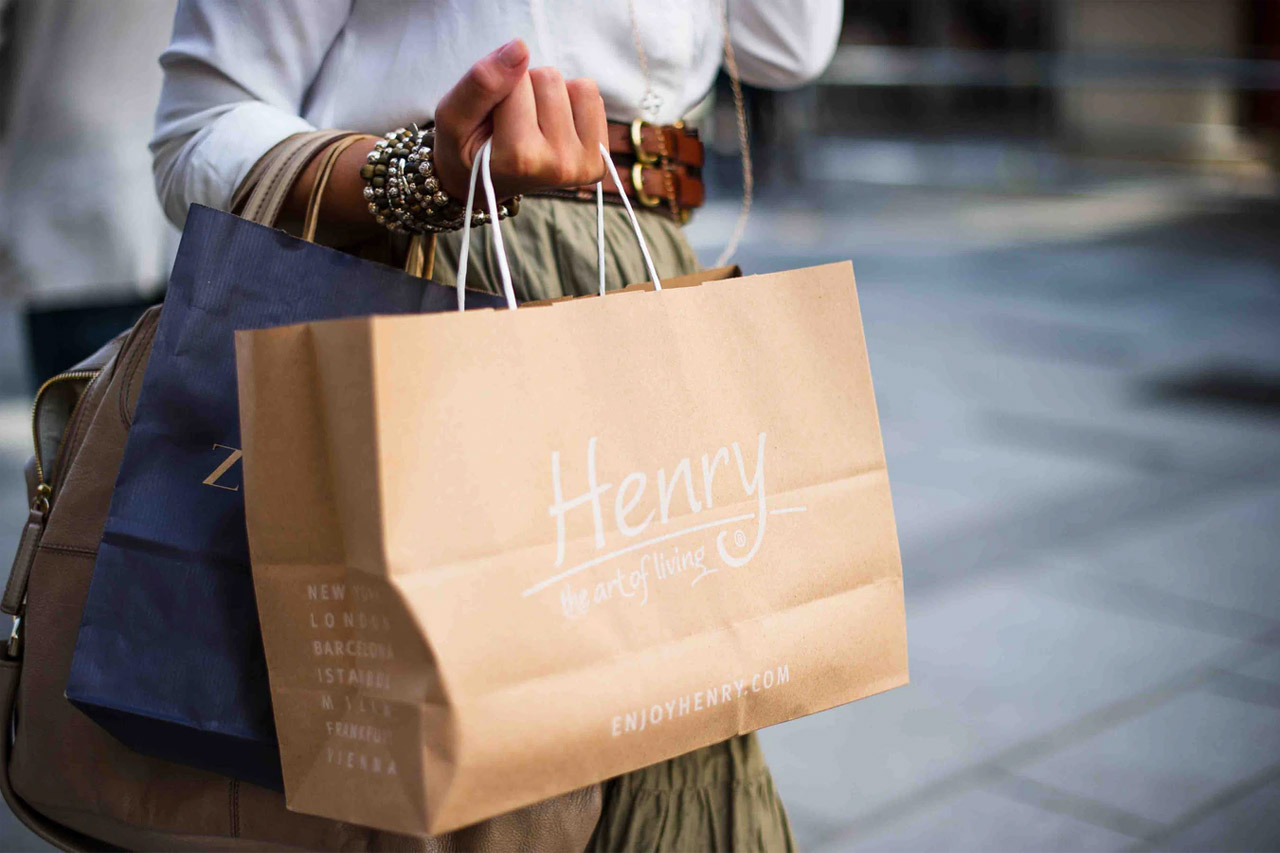 fashionable woman carrying designer bags